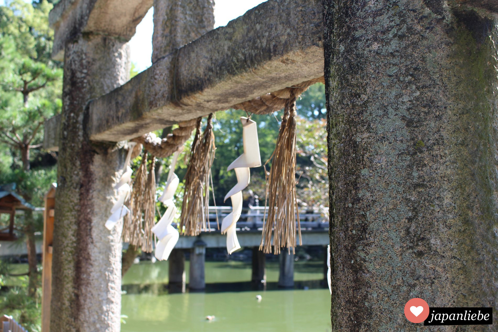 Stein-torii mit shide  Zickzack-Papier am Itsukushima Schrein in Kyōto.